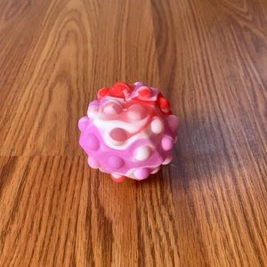 Tie dye pink and white and red and purple Pop it ball.
